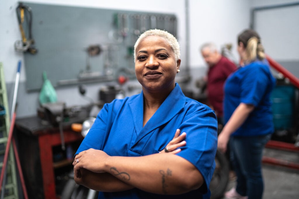 Worker wearing blue shirt smiling - flexible workforce