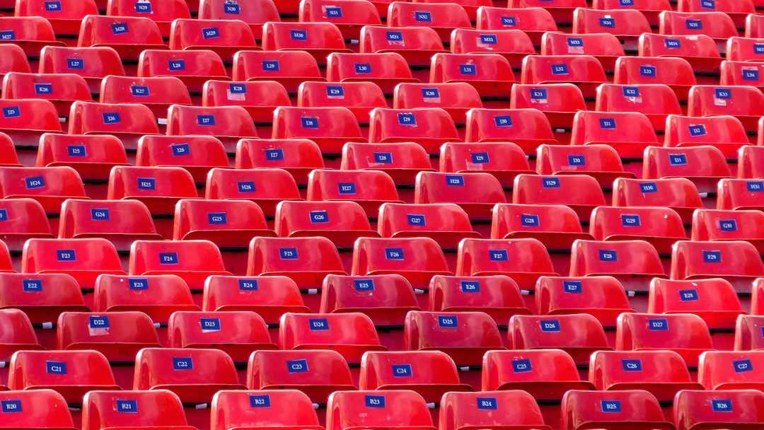 Red empty sport stadium chairs