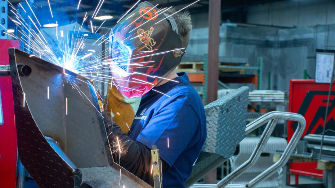 A welder welding with a mask