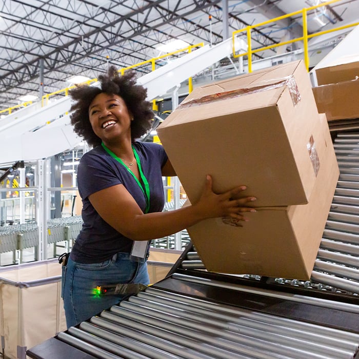 smiling woman stacking boxes