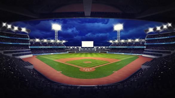 Empty baseball field in a baseball stadium at night. 